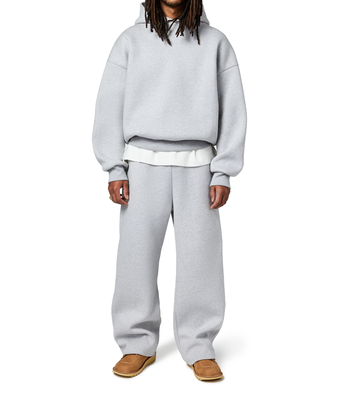 Person wearing a gray hoodie and pants on a white background