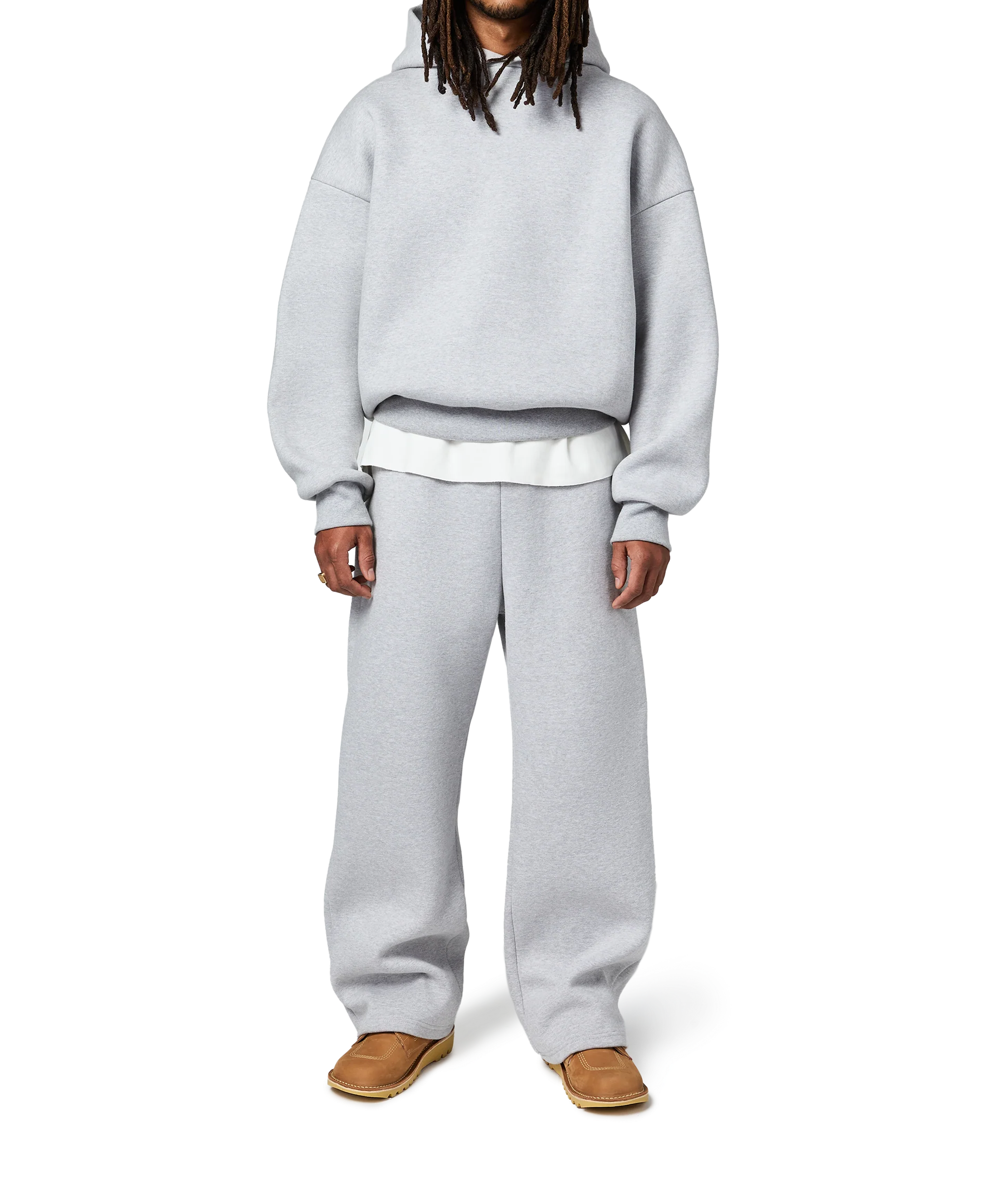Person wearing a gray hoodie and pants on a white background